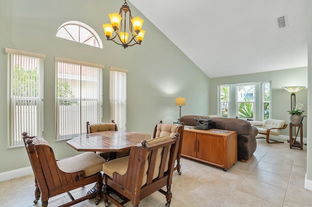 tiled dining area with high vaulted ceiling and an inviting chandelier