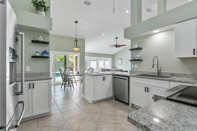 kitchen with sink, white cabinetry, hanging light fixtures, kitchen peninsula, and stainless steel appliances