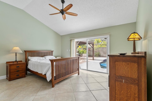 tiled bedroom featuring ceiling fan, access to exterior, vaulted ceiling, and a textured ceiling