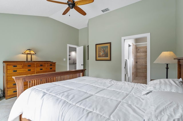 tiled bedroom with vaulted ceiling, connected bathroom, and ceiling fan