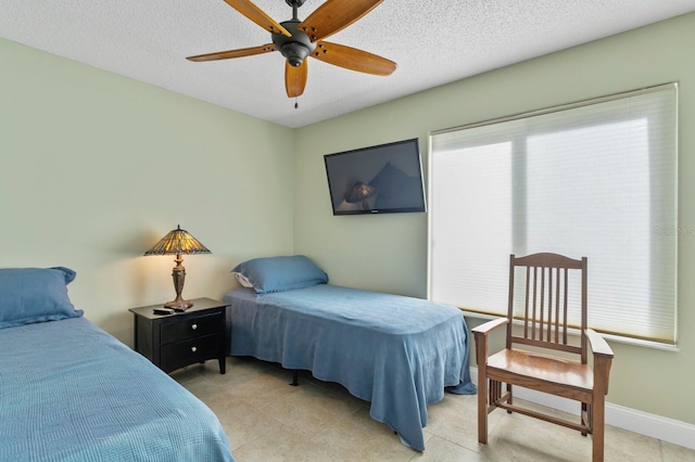 bedroom featuring ceiling fan and a textured ceiling