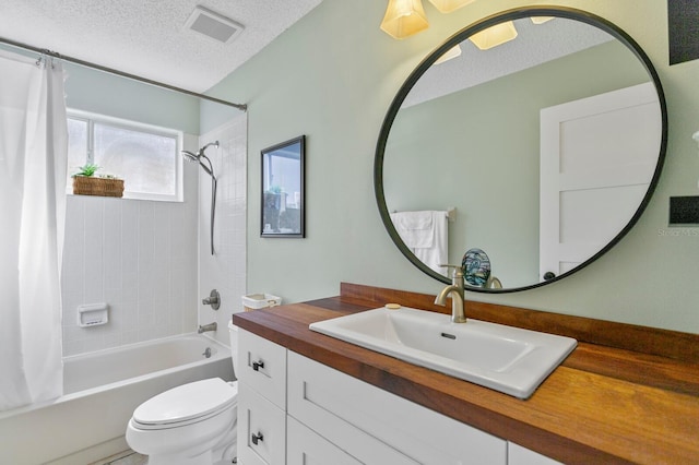 full bathroom featuring shower / tub combo, vanity, toilet, and a textured ceiling