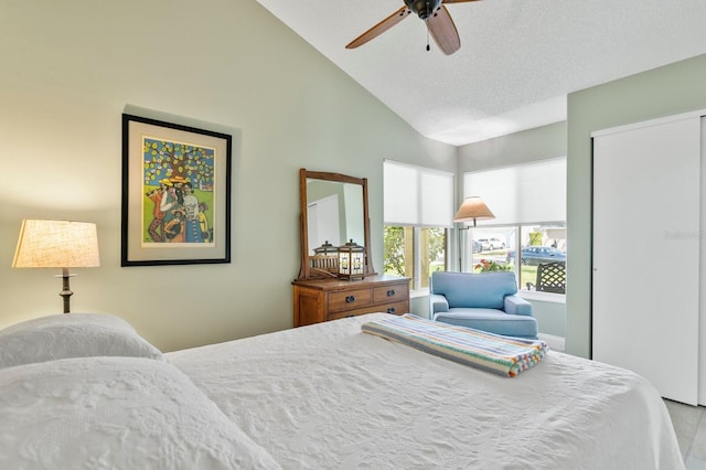 bedroom featuring high vaulted ceiling, a textured ceiling, and ceiling fan