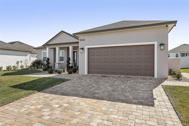 view of front facade featuring a porch, a garage, and a front lawn