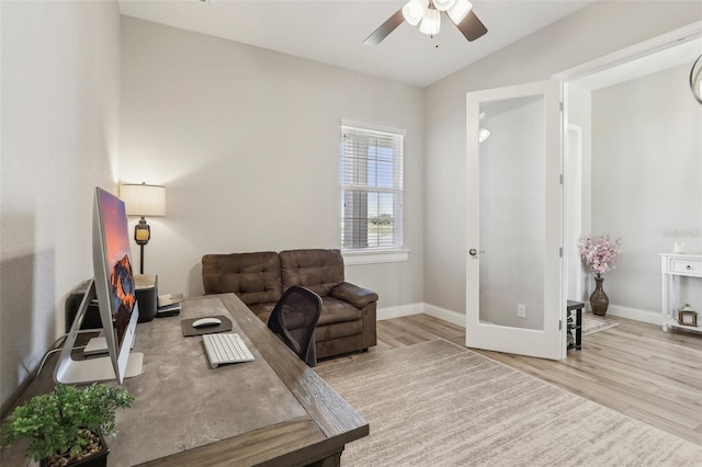 office space featuring ceiling fan, lofted ceiling, light wood-type flooring, and french doors