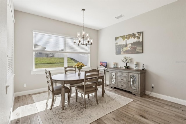 dining area featuring a chandelier and light hardwood / wood-style flooring