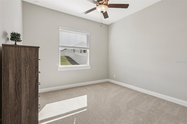 unfurnished room featuring ceiling fan and light colored carpet