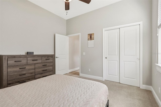 carpeted bedroom featuring ceiling fan and a closet