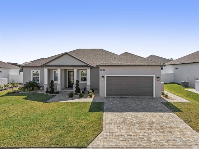 view of front of property with a porch, a garage, and a front yard