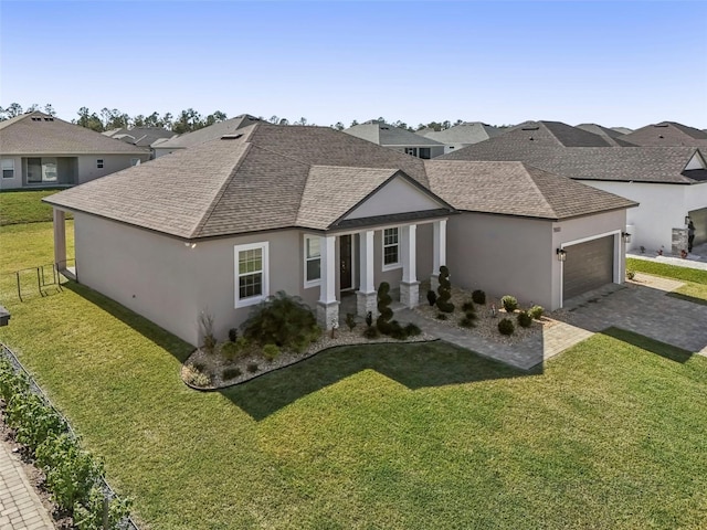 view of front of home featuring a garage and a front lawn