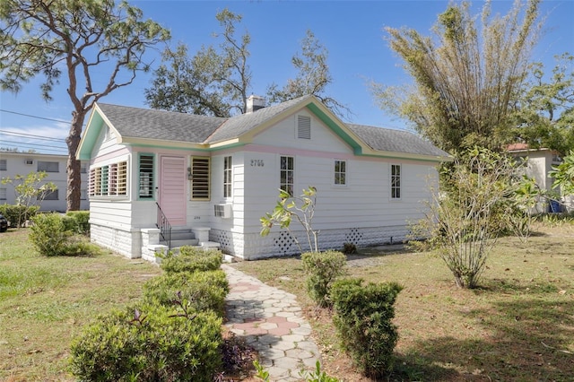 view of front of home featuring cooling unit and a front lawn