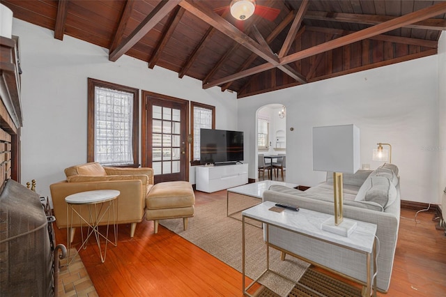 living room with wood ceiling, wood-type flooring, high vaulted ceiling, and beamed ceiling