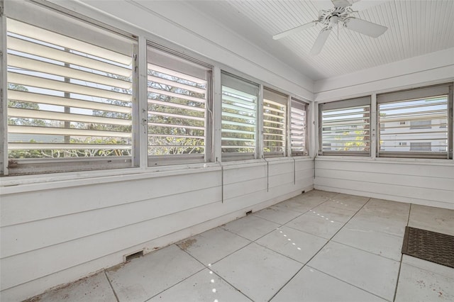 unfurnished sunroom featuring ceiling fan