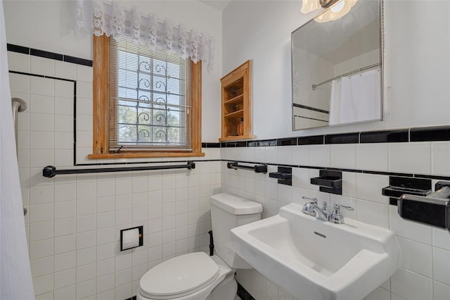 bathroom featuring tile walls, sink, and toilet