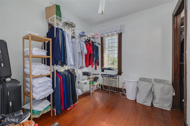 walk in closet with ceiling fan and dark hardwood / wood-style flooring