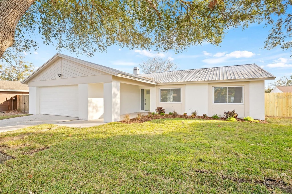 ranch-style house featuring a garage and a front yard