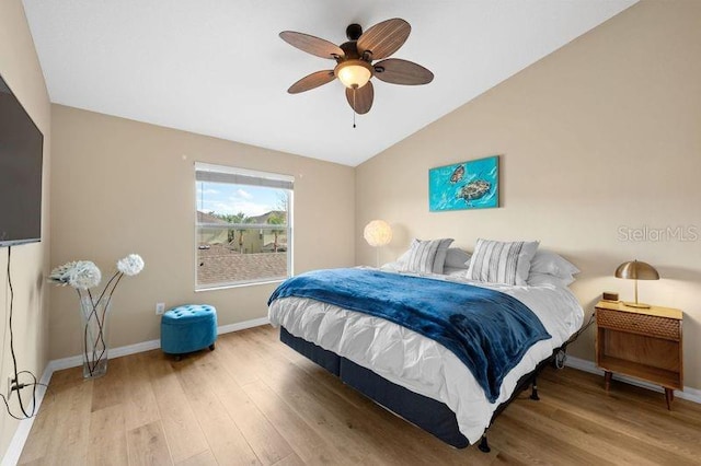 bedroom with hardwood / wood-style flooring, vaulted ceiling, and ceiling fan