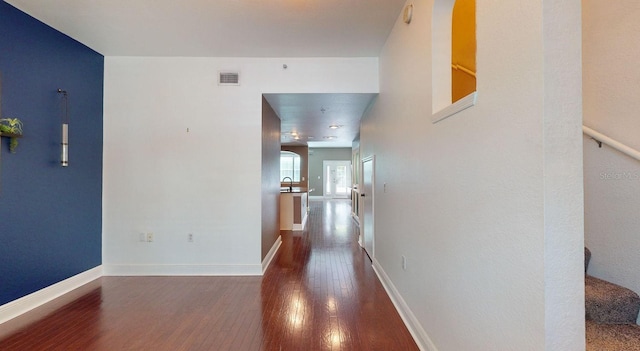 hallway featuring sink and dark hardwood / wood-style flooring