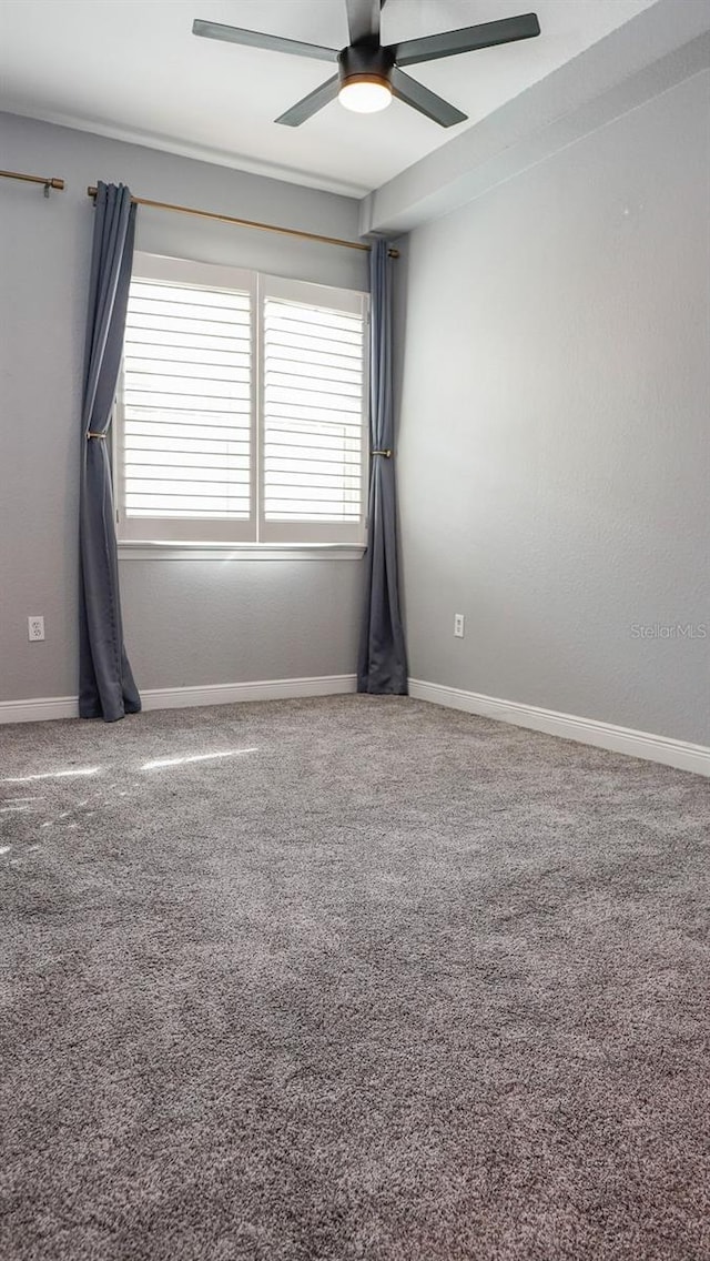 carpeted empty room with ceiling fan