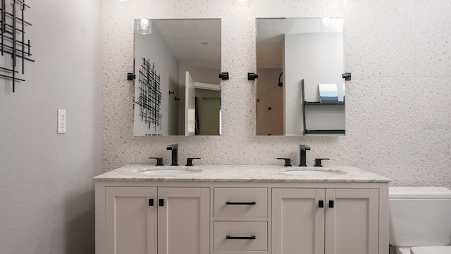 bathroom featuring tasteful backsplash, vanity, and toilet