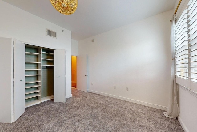 unfurnished bedroom with carpet and a closet