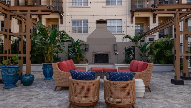 view of patio with an outdoor fireplace