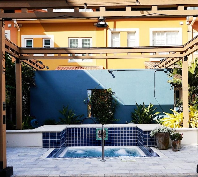 view of patio with an in ground hot tub