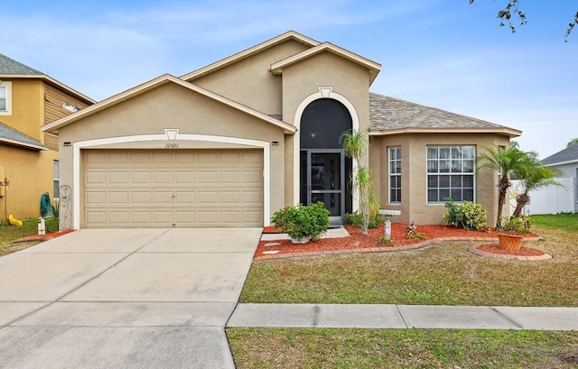 view of front of property featuring a garage and a front yard