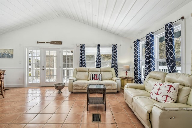 living room with light tile patterned flooring, lofted ceiling, and french doors