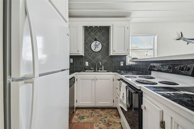 kitchen with electric stove, sink, white refrigerator, white cabinets, and decorative backsplash