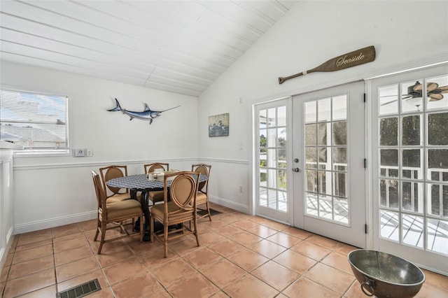 tiled dining space with lofted ceiling, plenty of natural light, and french doors