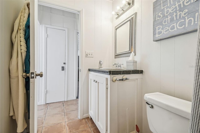 bathroom with vanity, tile patterned floors, and toilet