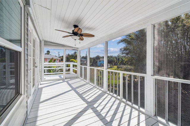 unfurnished sunroom featuring ceiling fan and wooden ceiling