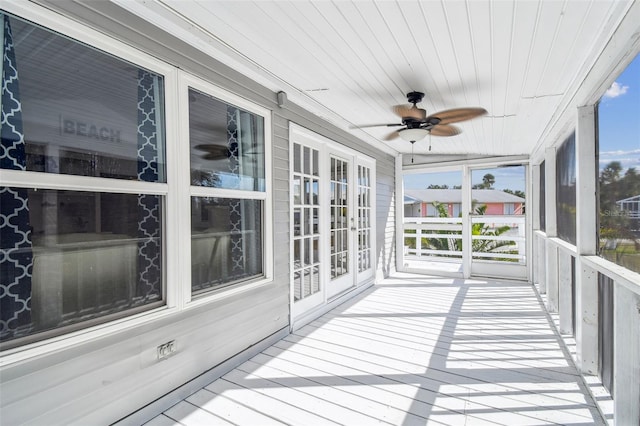 sunroom / solarium featuring wood ceiling and ceiling fan