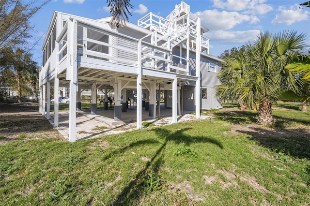 back of property featuring a patio area and a lawn