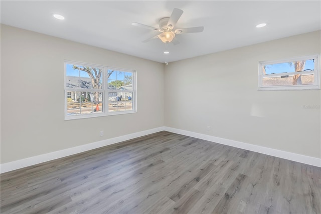 empty room with hardwood / wood-style floors and ceiling fan