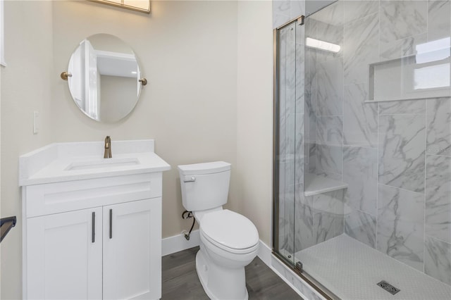 bathroom with toilet, an enclosed shower, hardwood / wood-style flooring, and vanity