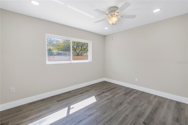 empty room with ceiling fan and hardwood / wood-style flooring