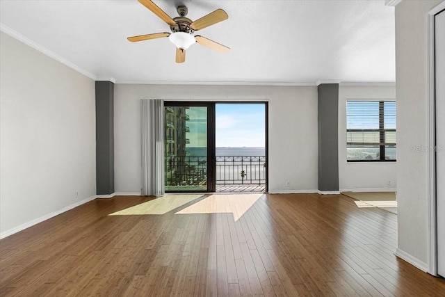 spare room featuring a water view, ceiling fan, ornamental molding, and dark hardwood / wood-style floors