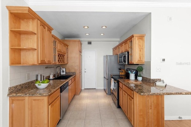 kitchen with sink, appliances with stainless steel finishes, dark stone countertops, backsplash, and light tile patterned flooring