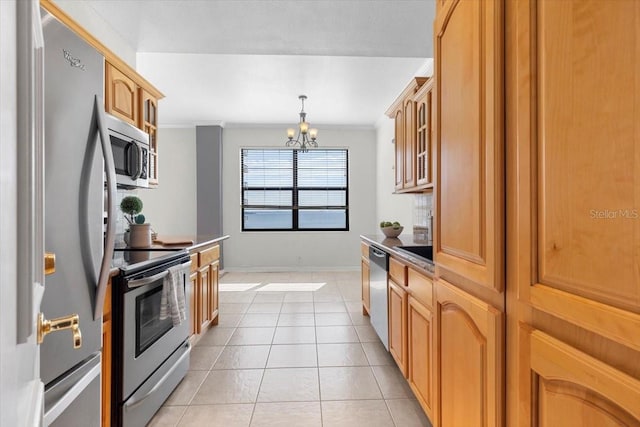 kitchen featuring pendant lighting, light tile patterned floors, crown molding, stainless steel appliances, and a notable chandelier