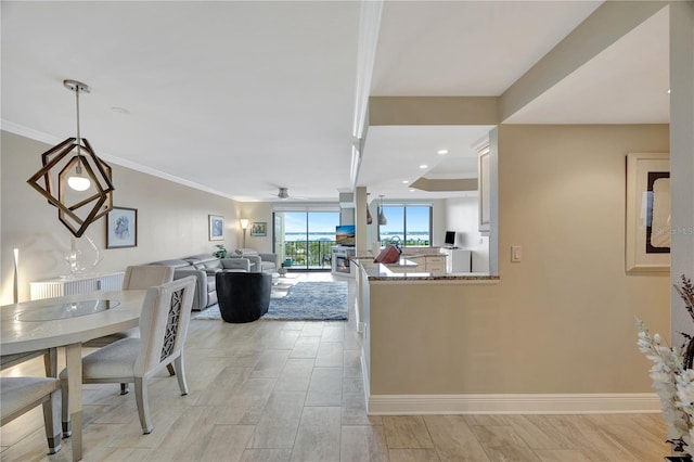 dining space featuring crown molding and ceiling fan