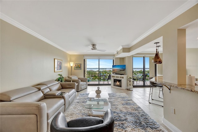 tiled living room featuring ornamental molding and ceiling fan