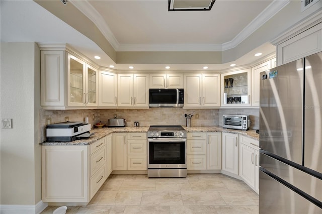 kitchen with light stone counters, crown molding, tasteful backsplash, and stainless steel appliances