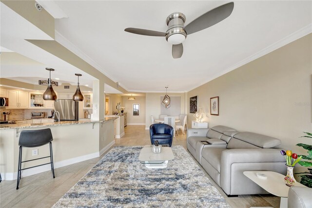 living room featuring crown molding and ceiling fan