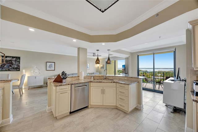 kitchen with sink, decorative light fixtures, stainless steel dishwasher, light stone countertops, and cream cabinetry