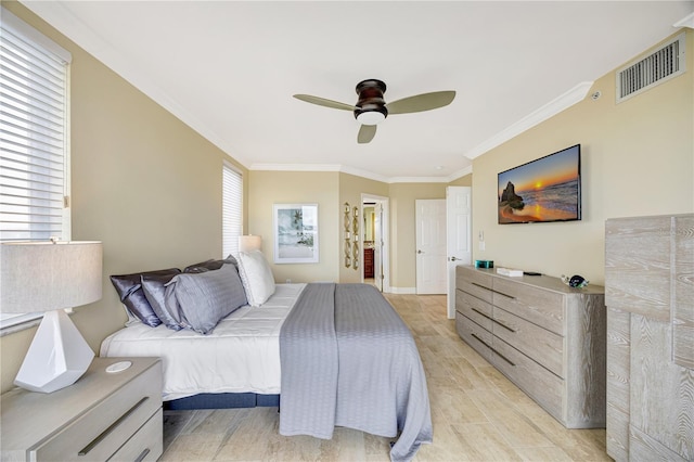 bedroom featuring crown molding, connected bathroom, ceiling fan, and light hardwood / wood-style flooring