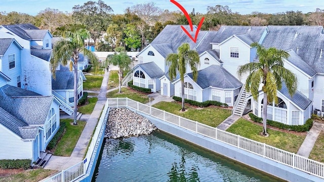 bird's eye view with a water view and a residential view