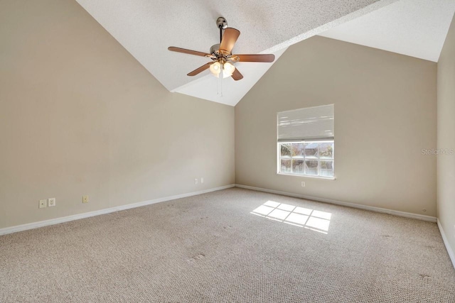 spare room featuring lofted ceiling, ceiling fan, a textured ceiling, and carpet flooring