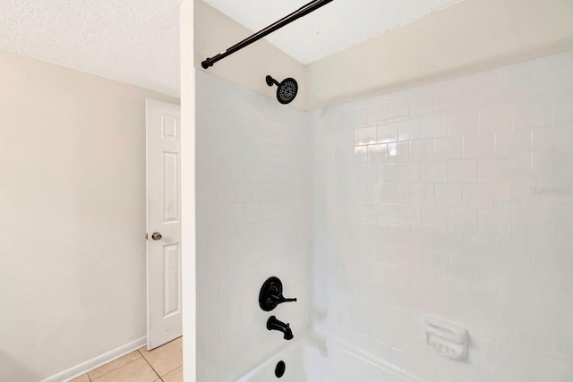 bathroom with tile patterned floors, bathing tub / shower combination, and a textured ceiling